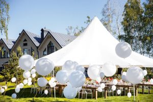 white balloons and large tent in yard
