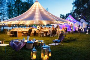 outdoor party with large tent and lights