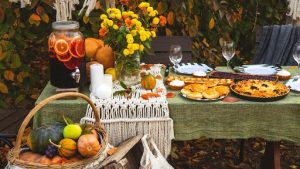 table with pumpkins pies and flowers