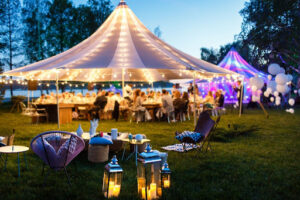 outdoor party with large tent and lights